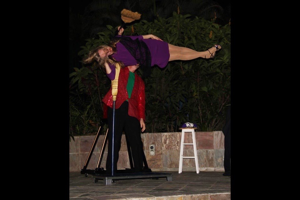 A woman is performing on stage with a microphone.